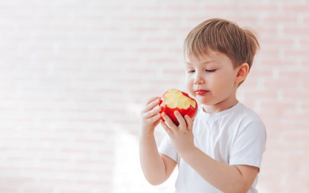 healthy boy chews apple